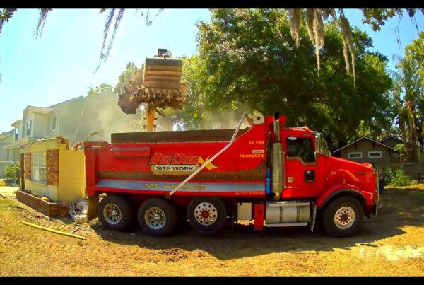 red dump truck at home demolition in Orlando, Florida