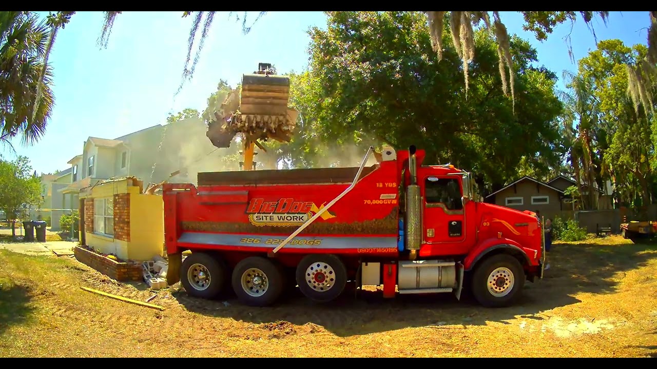 red dump truck at home demolition in Orlando, Florida