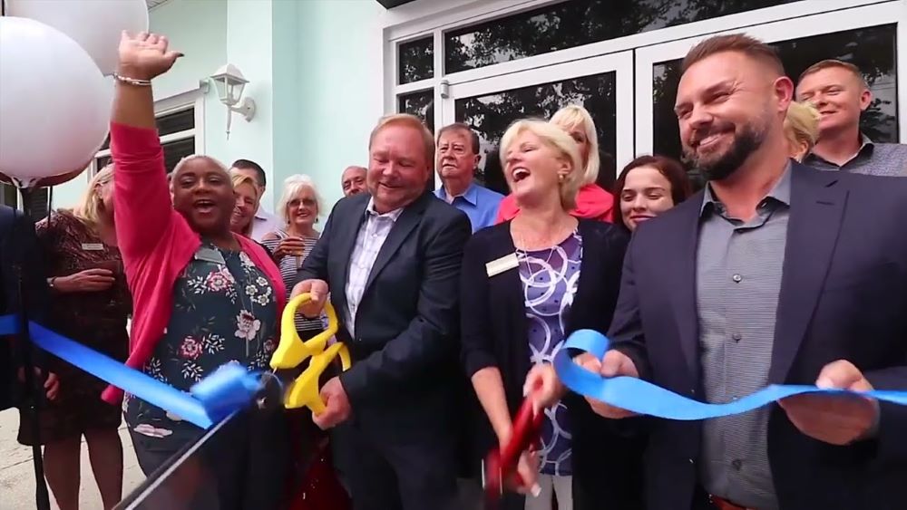 The Newberry team celebrates the opening of a new office with ribbon cutting ceremony