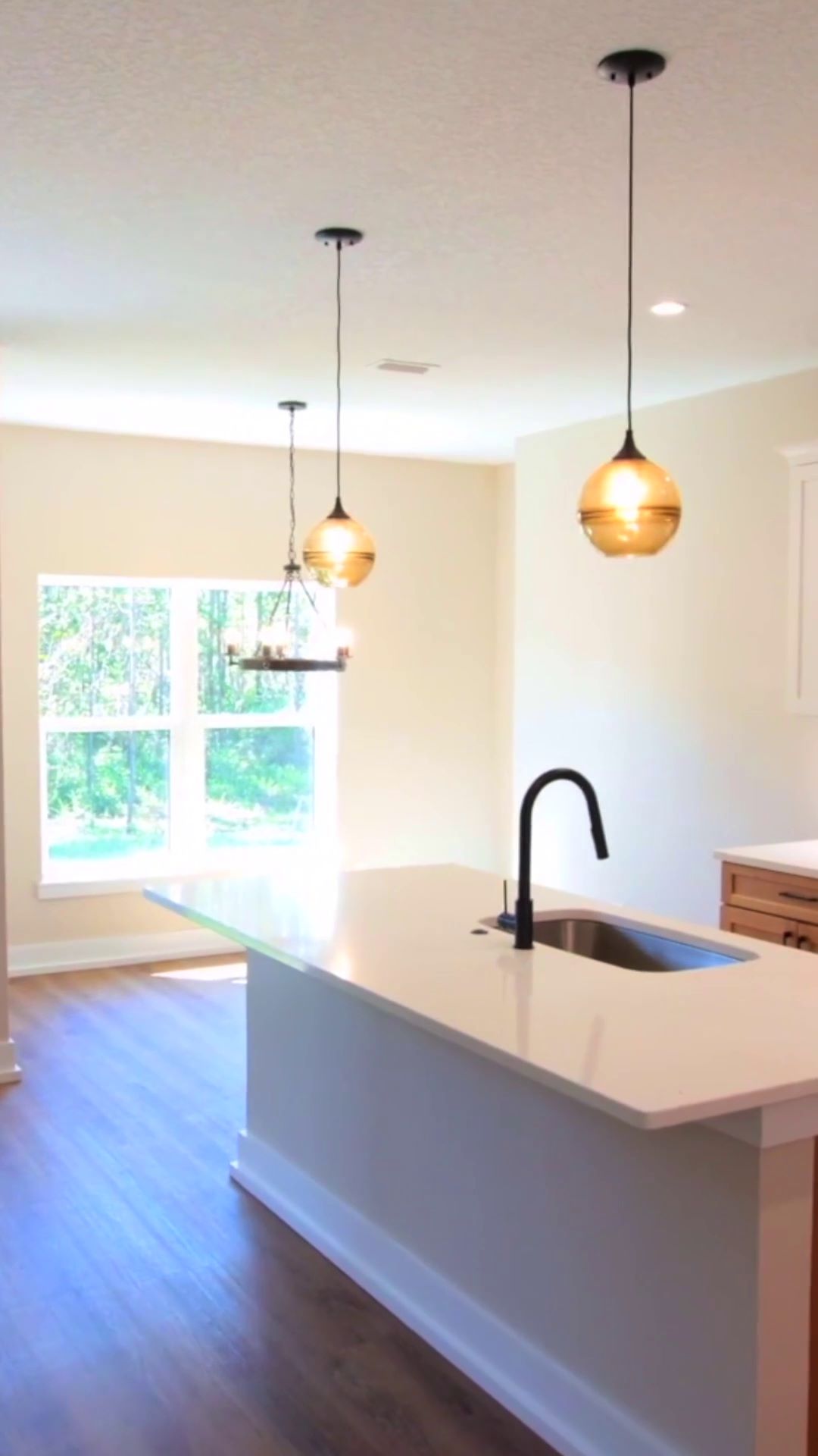 kitchen island and dining area in a finished steel frame home project