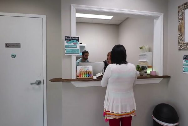 woman checks in at reception desk in a yoga studio and wellness center