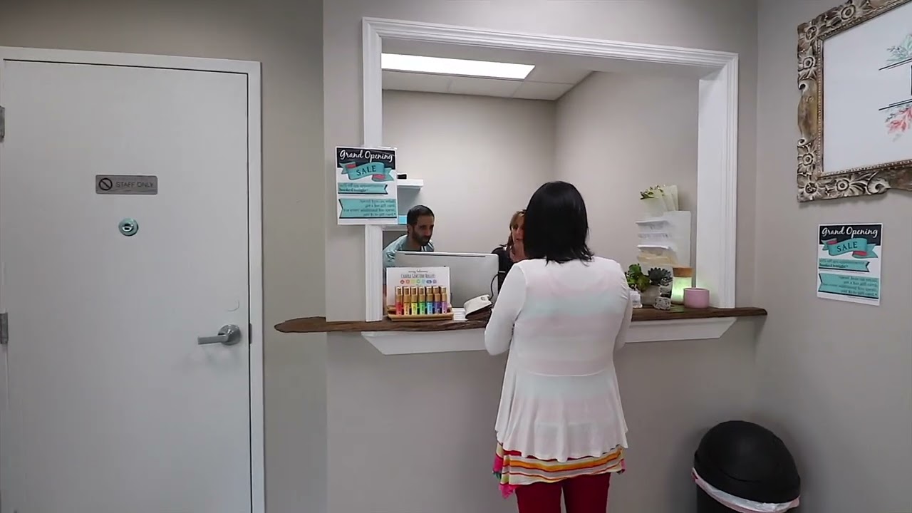 woman checks in at reception desk in a yoga studio and wellness center