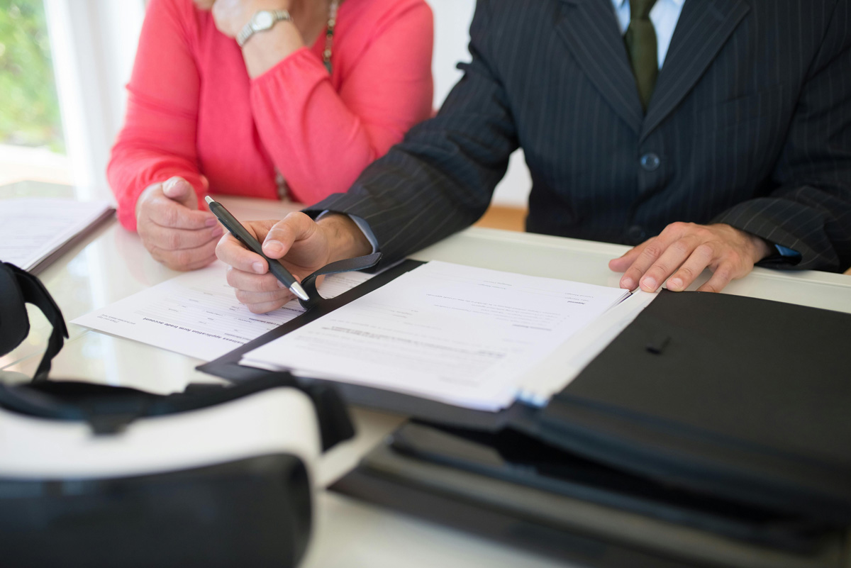 couple signs paperwork