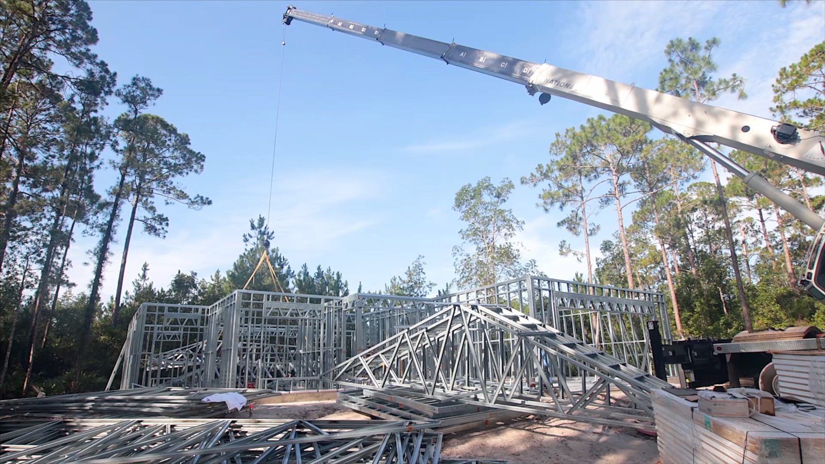 construction crane at work site with steel frame home 