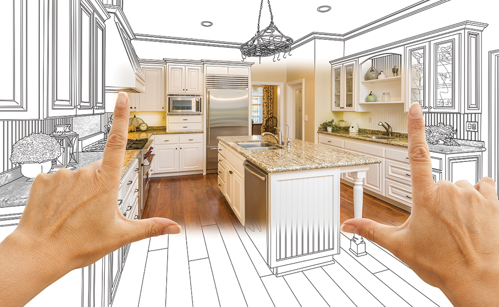 hands held up in framing pose over view of kitchen rendering becoming a real kitchen